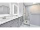 Elegant bathroom featuring a glass shower, marble floors, and modern vanity with double sinks at 835 Dyson Dr, Winter Springs, FL 32708