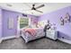 Charming bedroom featuring light purple walls, and white furniture with ample natural light at 835 Dyson Dr, Winter Springs, FL 32708