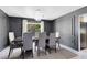 Contemporary dining room with dark walls, modern lighting, and stylish neutral furniture at 835 Dyson Dr, Winter Springs, FL 32708