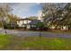 Charming home exterior with a well-manicured lawn, mature trees, and a winding driveway at 835 Dyson Dr, Winter Springs, FL 32708