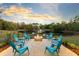 Outdoor fire pit area provides a cozy space for gathering and enjoying the scenic views of the pond and sunset at 835 Dyson Dr, Winter Springs, FL 32708