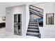 Hallway with a built in dual zone wine refrigerator with a staircase in the background at 835 Dyson Dr, Winter Springs, FL 32708