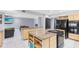 Open concept kitchen features an island cooktop and a view into the living area at 835 Dyson Dr, Winter Springs, FL 32708