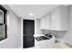 Functional laundry room with updated appliances, and ample cabinet space at 835 Dyson Dr, Winter Springs, FL 32708