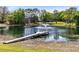 Beautiful pond view with fountain, wooden dock and seating, providing a serene outdoor retreat at 835 Dyson Dr, Winter Springs, FL 32708