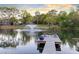 Waterfront pond with a dock featuring sitting area offering picturesque views and tranquil ambiance at 835 Dyson Dr, Winter Springs, FL 32708