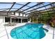Backyard pool enclosed with screened cage with outdoor dining area at 835 Dyson Dr, Winter Springs, FL 32708