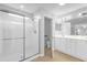 Bathroom with a glass-enclosed shower and a double sink vanity at 8602 Se 133Rd Ln, Summerfield, FL 34491