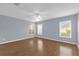 Spacious bedroom features a ceiling fan, wood-look flooring and three windows at 8602 Se 133Rd Ln, Summerfield, FL 34491