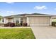 Charming single-story home featuring a well-maintained lawn and a two-car garage at 8602 Se 133Rd Ln, Summerfield, FL 34491