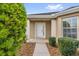 Inviting front entrance with meticulously maintained landscaping and a covered entryway at 8602 Se 133Rd Ln, Summerfield, FL 34491