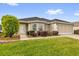 Attractive single-Gathering home with lush green lawn and manicured landscaping at 8602 Se 133Rd Ln, Summerfield, FL 34491