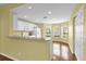 Bright kitchen with white cabinets and an open view to the dining and living areas at 8602 Se 133Rd Ln, Summerfield, FL 34491