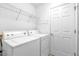 Neat laundry room with a washer, dryer and shelving for easy storage at 8602 Se 133Rd Ln, Summerfield, FL 34491