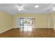 Open concept living room with hardwood floors and sliding glass doors to the sunroom at 8602 Se 133Rd Ln, Summerfield, FL 34491