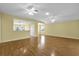 Open living area with hardwood floors, ceiling fans, and views of the kitchen at 8602 Se 133Rd Ln, Summerfield, FL 34491