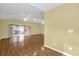 Spacious living room featuring hardwood floors, ceiling fans, and sliding glass doors at 8602 Se 133Rd Ln, Summerfield, FL 34491
