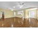 Spacious living room showing open floor plan, hardwood floors, and access to the kitchen at 8602 Se 133Rd Ln, Summerfield, FL 34491