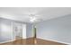 Large main bedroom with wood-look flooring, ceiling fan and en-suite bath at 8602 Se 133Rd Ln, Summerfield, FL 34491
