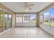 Enclosed patio with windows, a ceiling fan, and access to the backyard area at 8602 Se 133Rd Ln, Summerfield, FL 34491