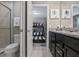 Bathroom featuring granite counters, dark cabinetry, with a view of a bunkbed room at 8892 Bengal Ct, Kissimmee, FL 34747
