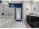 Bathroom featuring granite counters, dark cabinetry, and a combined shower and tub at 8892 Bengal Ct, Kissimmee, FL 34747