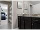 Bathroom featuring granite counters, dark cabinetry, with a view of a bedroom at 8892 Bengal Ct, Kissimmee, FL 34747