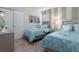 Bedroom with two beds, soft carpet, fan, and sliding closet doors at 8892 Bengal Ct, Kissimmee, FL 34747