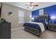 A bedroom with a modern design featuring a bed with storage and a blue accent wall at 8892 Bengal Ct, Kissimmee, FL 34747