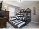 A ' bedroom with a bunk bed, pull-out trundle bed, and blue and white striped bedding at 8892 Bengal Ct, Kissimmee, FL 34747