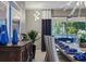 An elegant dining room with dark wood furniture, unique vases, decor and natural light from the large windows at 8892 Bengal Ct, Kissimmee, FL 34747