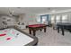 Spacious game room with air hockey, pool table, and foosball at 8892 Bengal Ct, Kissimmee, FL 34747