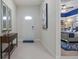 Hallway view featuring a console table and view to a bedroom with blue decor at 8892 Bengal Ct, Kissimmee, FL 34747