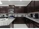 Well-equipped kitchen with granite countertops, stainless steel appliances, and dark cabinetry at 8892 Bengal Ct, Kissimmee, FL 34747