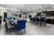 Open-concept living space with a large dining table, kitchen with bar seating and a comfortable living area at 8892 Bengal Ct, Kissimmee, FL 34747