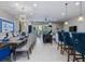 A large open-concept living and dining space featuring modern furniture, a view of the patio and a kitchen at 8892 Bengal Ct, Kissimmee, FL 34747