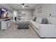 Comfortable living room featuring a large white sectional sofa, a patterned ottoman, and stylish decor for relaxation at 8892 Bengal Ct, Kissimmee, FL 34747