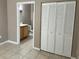 Bedroom featuring a tile floor, closet and bathroom in view at 9021 Lee Vista Blvd # 1707, Orlando, FL 32829