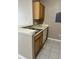Bright kitchen with white countertops, wood cabinets and tile floor at 9021 Lee Vista Blvd # 1707, Orlando, FL 32829
