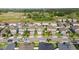 Aerial view of a residential street showing houses with brick driveways and mature trees at 903 Sydney St, Davenport, FL 33837