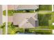 Birds eye view of a home featuring a well maintained roof, brick driveway and fenced backyard at 903 Sydney St, Davenport, FL 33837