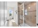 Bright bathroom featuring tiled walk-in shower with glass doors and view into the window at 903 Sydney St, Davenport, FL 33837