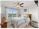 Bedroom with ceiling fan, large window, view into the neighborhood and a wreath hanging above the bed at 903 Sydney St, Davenport, FL 33837