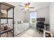 Bedroom with neutral tones, a ceiling fan and a desk with rolling chair next to the window at 903 Sydney St, Davenport, FL 33837