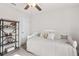 Cozy bedroom with neutral tones, ceiling fan, and decorative shelving to the side of bed at 903 Sydney St, Davenport, FL 33837