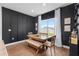 Stylish dining room with black accent wall, modern table set, and bright window view at 903 Sydney St, Davenport, FL 33837