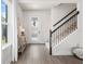Inviting home foyer with wood floors, staircase, decorative lighting, and natural light from window at 903 Sydney St, Davenport, FL 33837