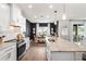 Well-lit kitchen with a dining area, black accent wall, and modern appliances at 903 Sydney St, Davenport, FL 33837