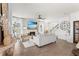 Bright living room features a fireplace with TV, ceiling fan, wood floors, and neutral furniture at 903 Sydney St, Davenport, FL 33837