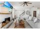 Spacious living room featuring a fireplace, ceiling fan, and an adjacent staircase at 903 Sydney St, Davenport, FL 33837